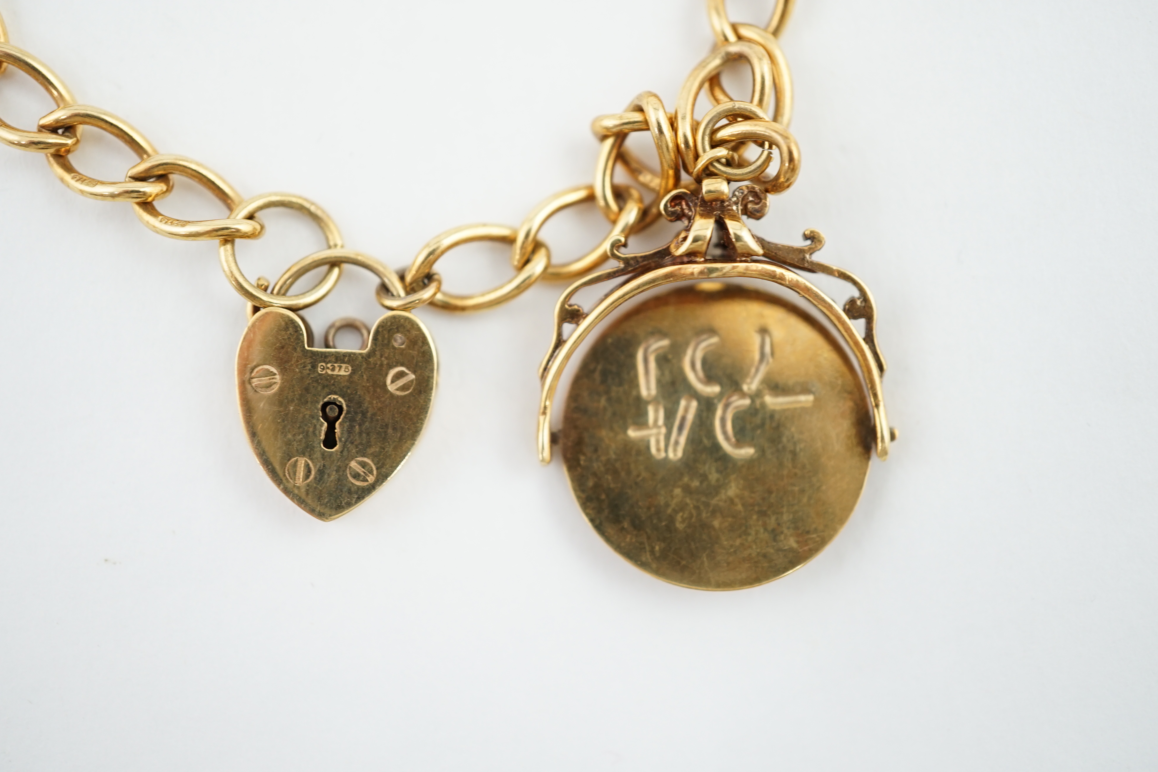 A 1960's 9ct gold oval link charm bracelet